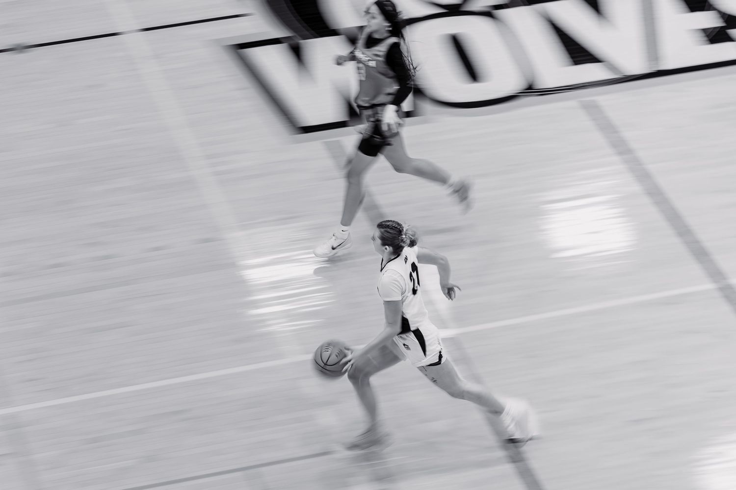 #22 Taryn Mitchell of the Algonquin Wolves Women's Basketball advancing the ball against the Seneca Sting.