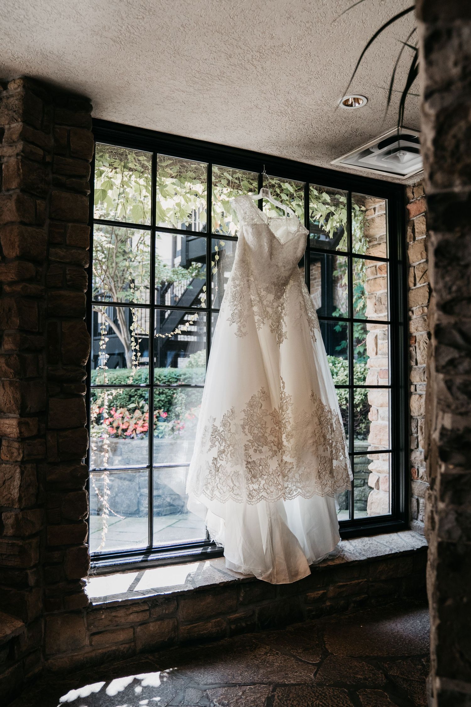 Bride's dress hanging from a window at the Old Mill, Toronto