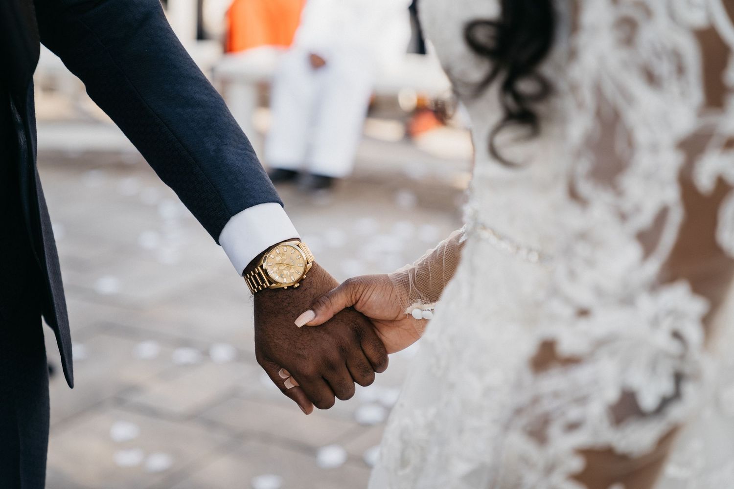 Newly married couple embraces hands at outdoor wedding outside of Ottawa Ontario.
