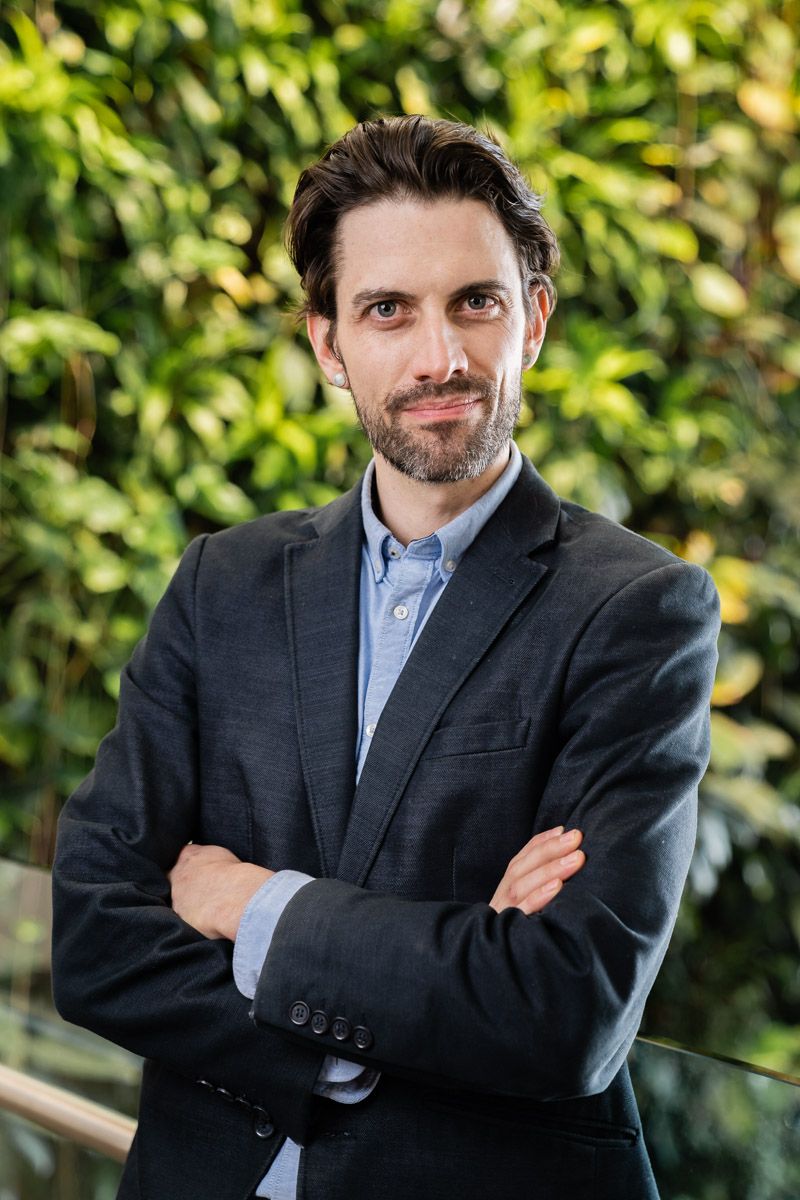 Artificially lit corporate headshot of a man in a suit at Carleton University in Ottawa Ontario.