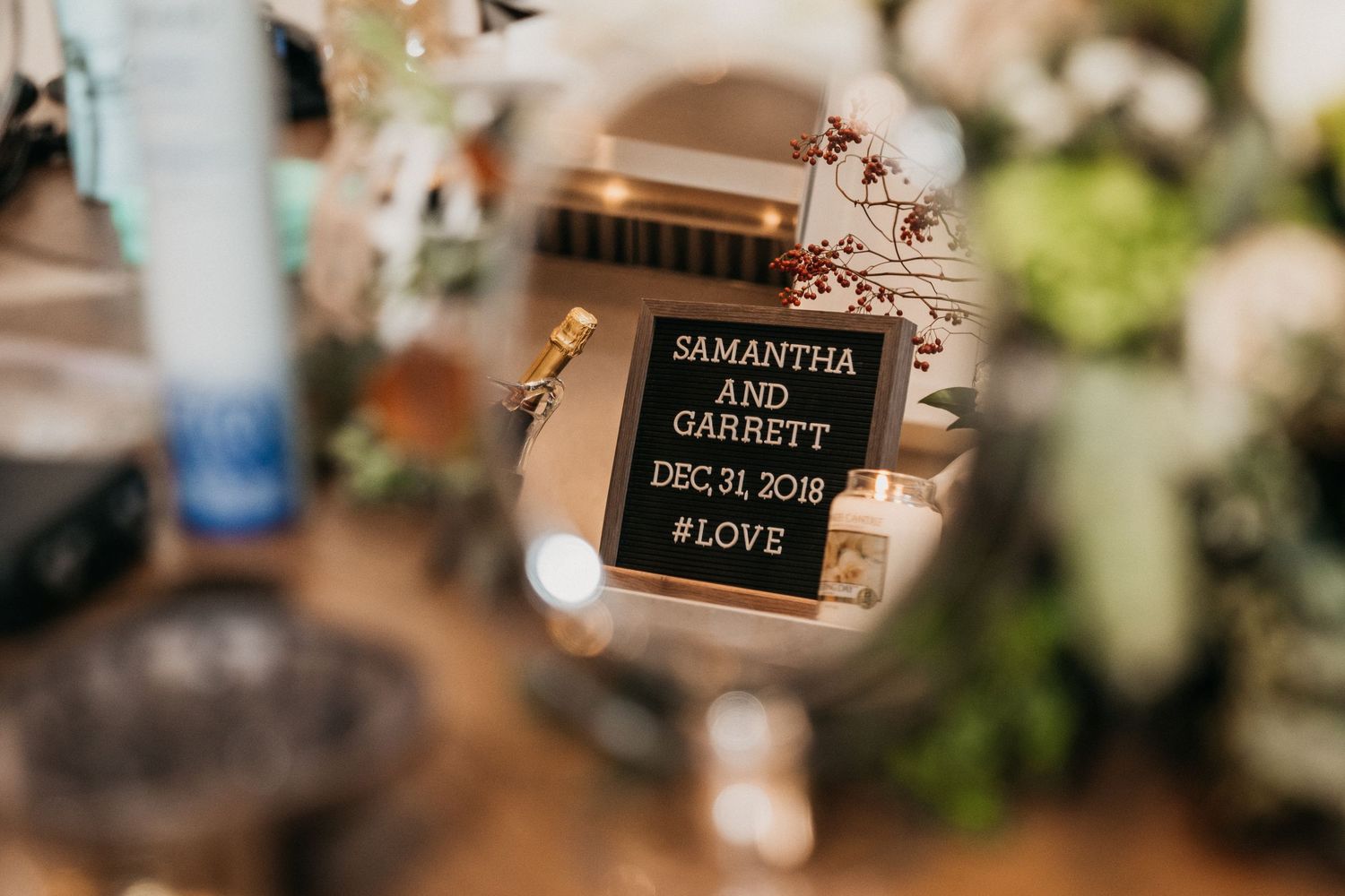 Reflection of a couple's wedding announcement through a vanity mirror.