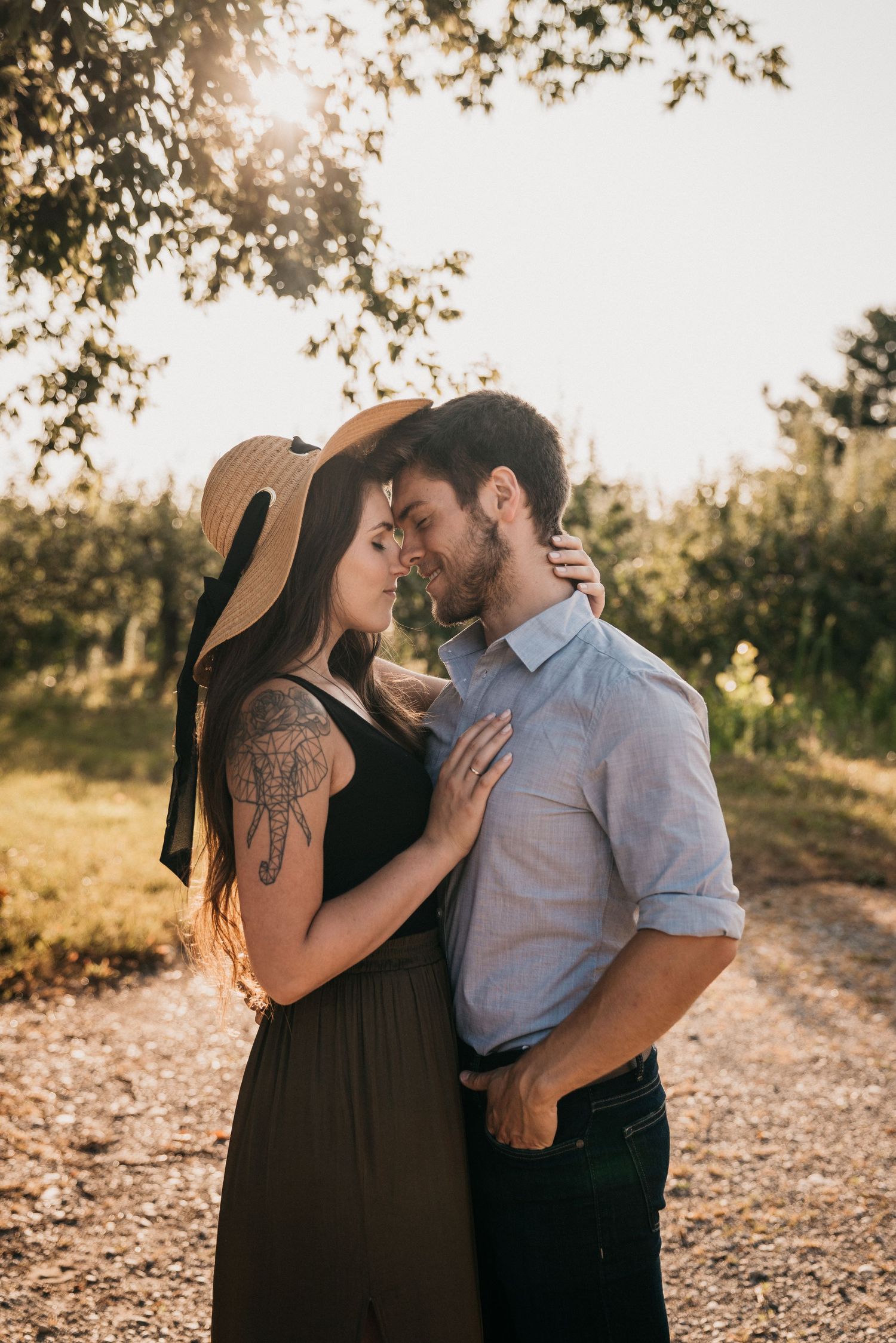 A couple shares an intimate moment during golden hour