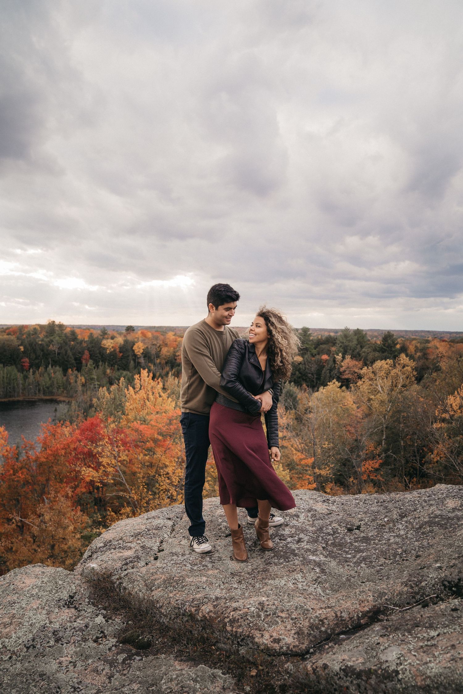 Muskoka outdoor engagement session with breathtaking fall colours in the background.