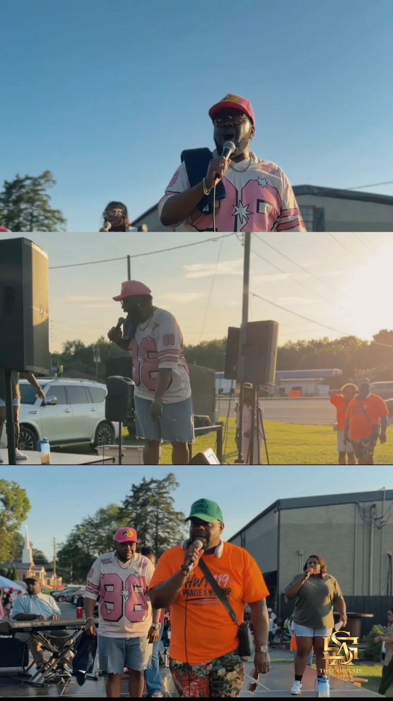Three men in sports jerseys gather outdoors at a community event, one speaking into a microphone under a clear blue sky.