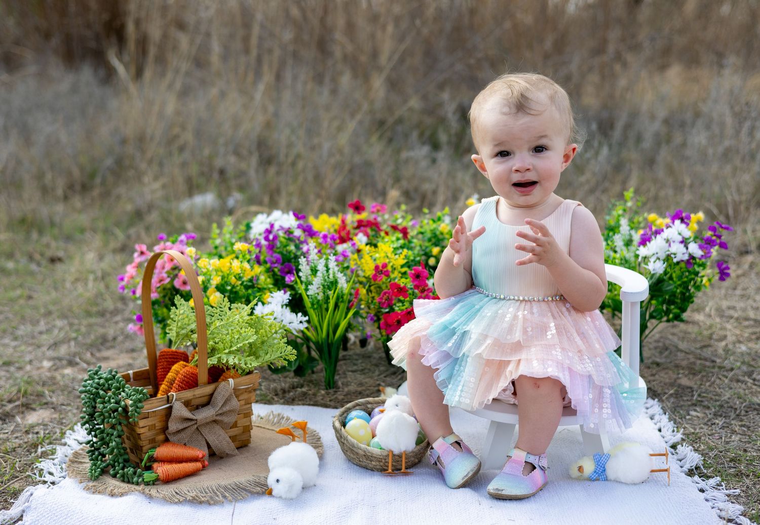 A spring garden tea party setup with floral arrangements, vintage teacups, and rustic decor against a natural outdoor backdrop.