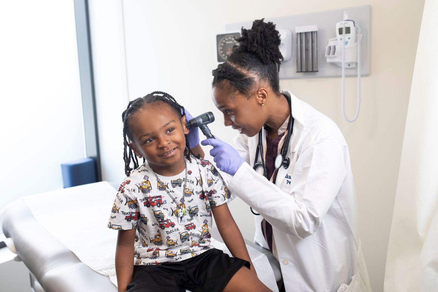 Medical examination taking place in a bright clinical setting with modern equipment.
