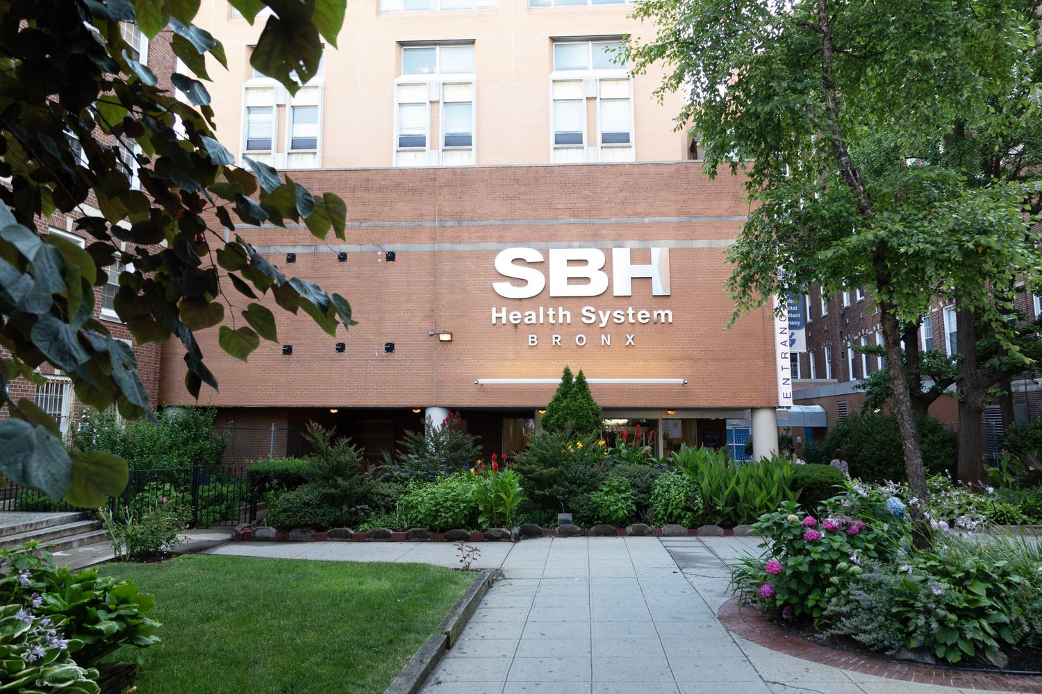 Exterior view of a modern medical facility with landscaped grounds and walkways.