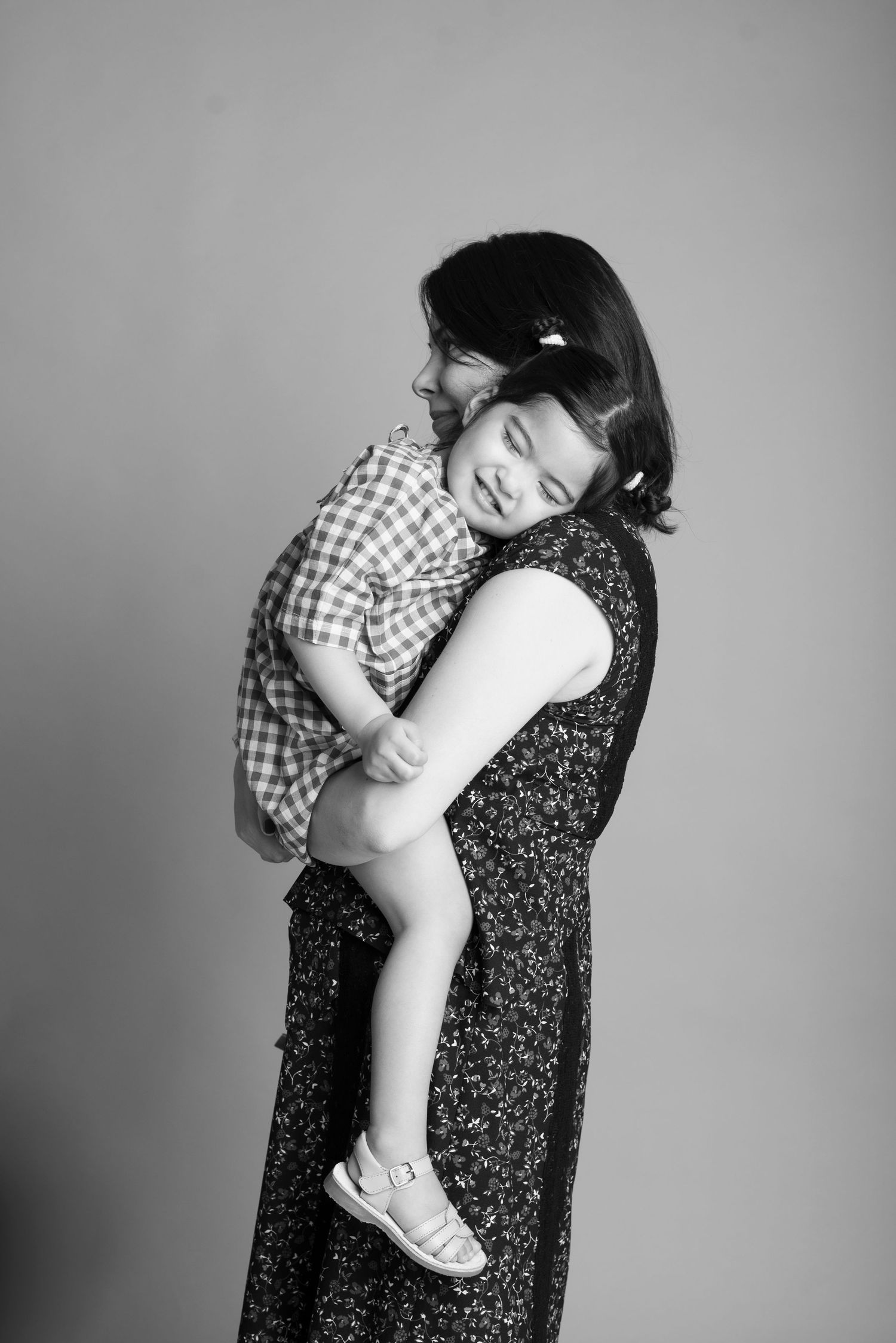 Black and white portrait series showing tender moments between parent and child.