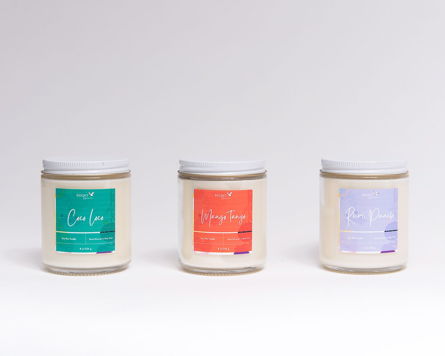 Minimalist product photography of skincare jars with pastel colored labels on white background.