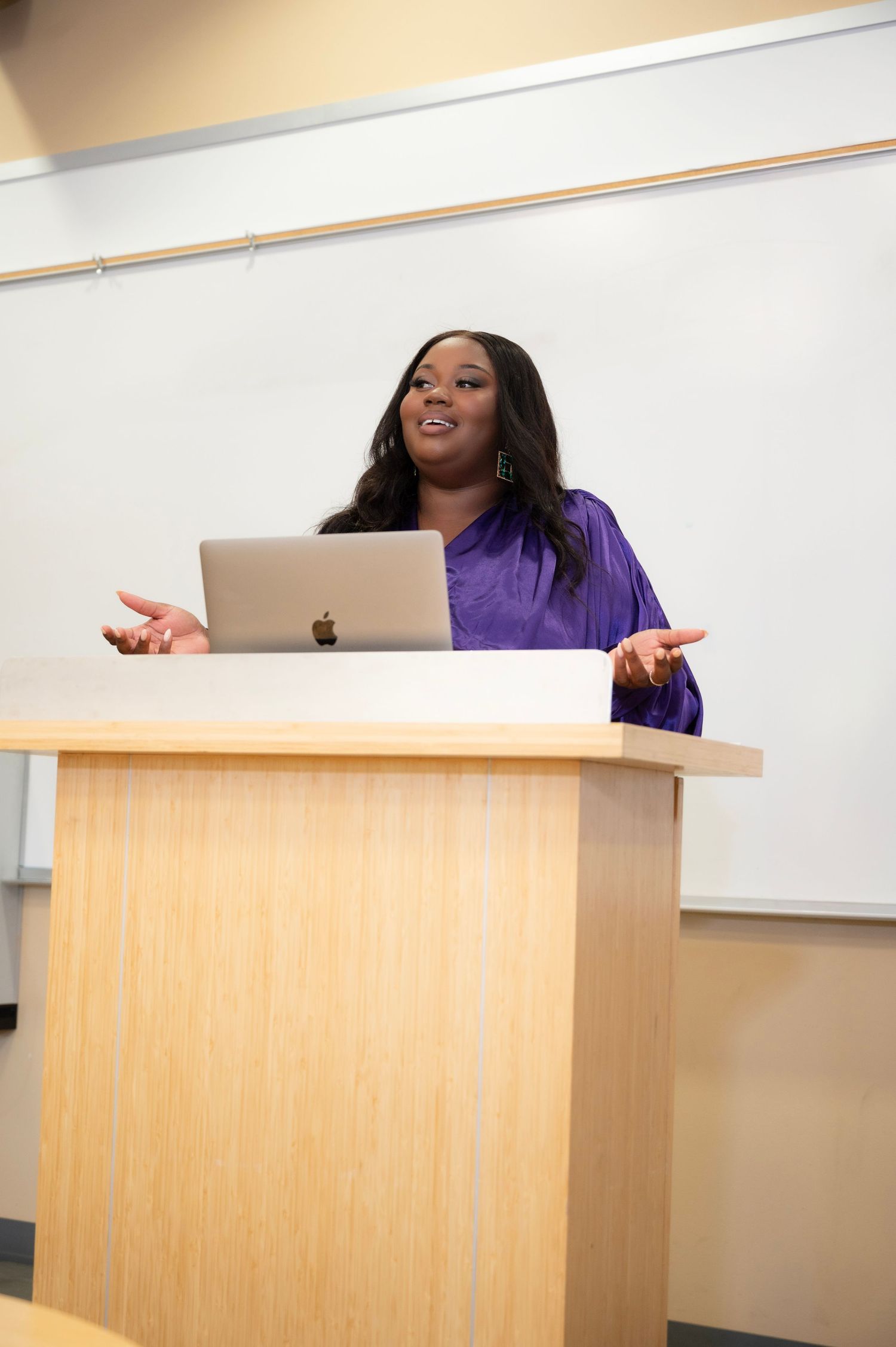 Series of dynamic presentation shots at wooden podium in classroom setting.