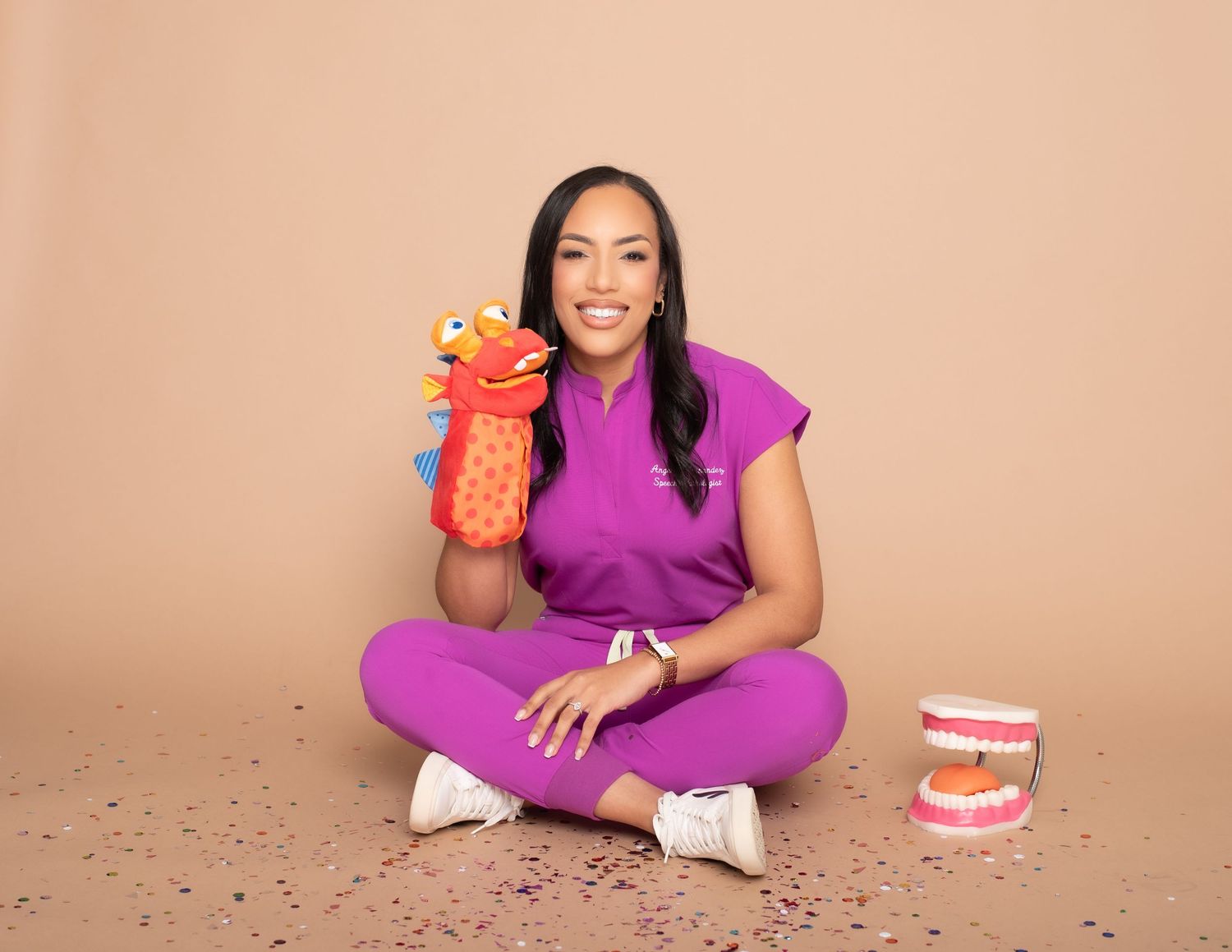 Casual lifestyle photoshoot with purple outfit and gift boxes against beige background.