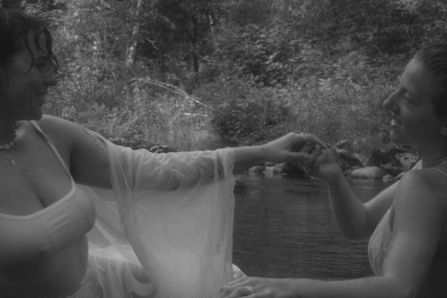 LGBTQ couple, storytelling, documentary photography session, black and white image of couple holding hands,