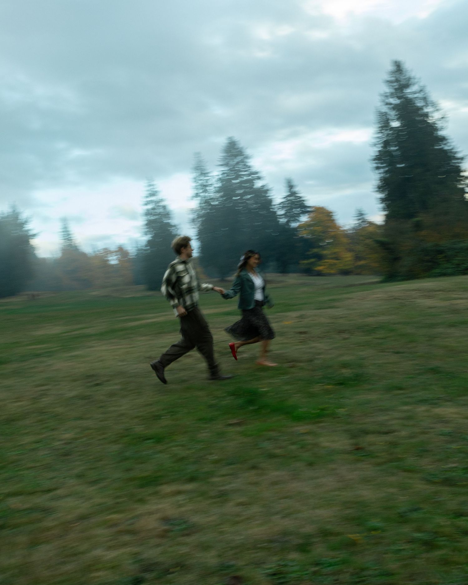 Couple runs around together in a field. Fall couples session bc, documentary, prompted photography