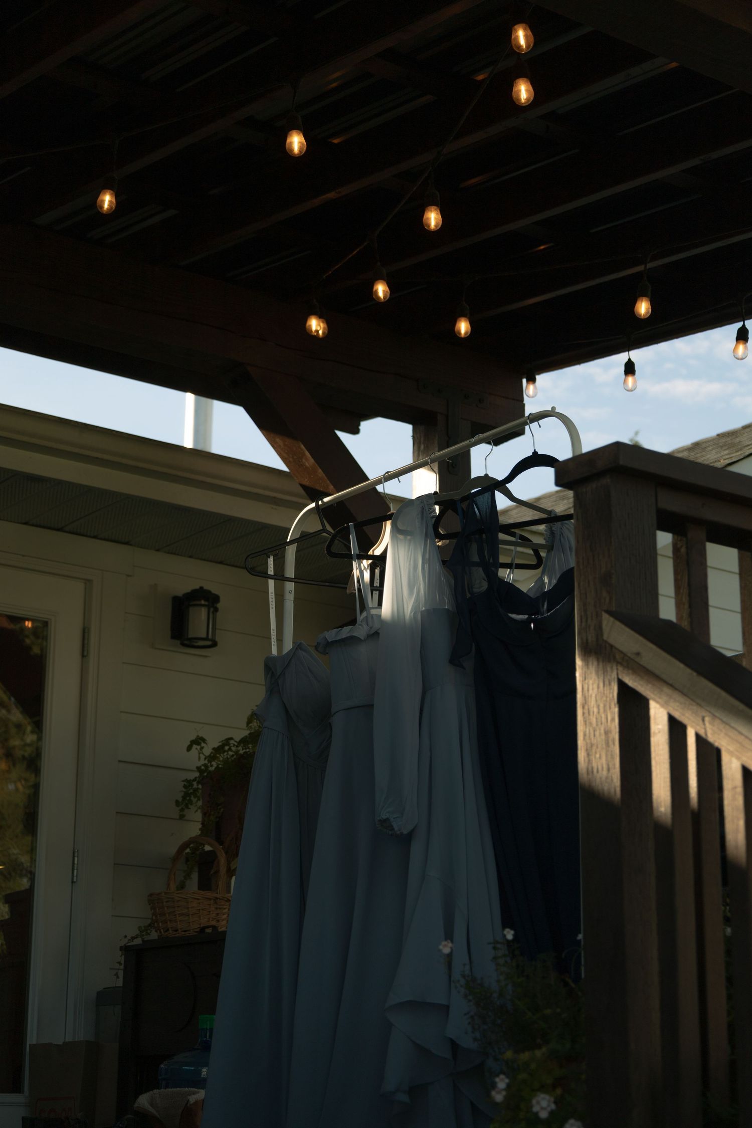 Getting ready wedding photography, bridesmaids dressing hanging outside, sunlight dotting them