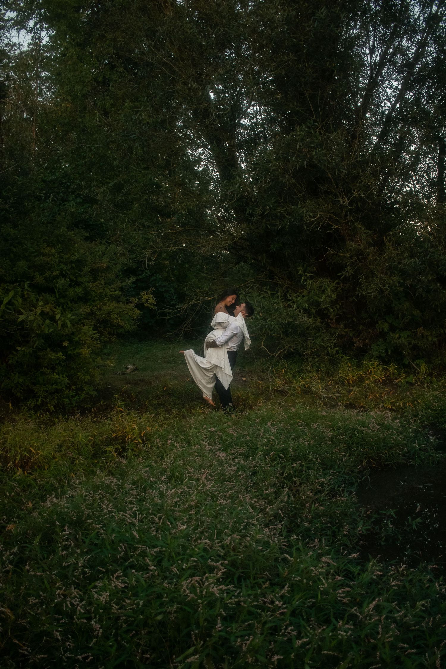 Woman being lifted into the air, engagement session