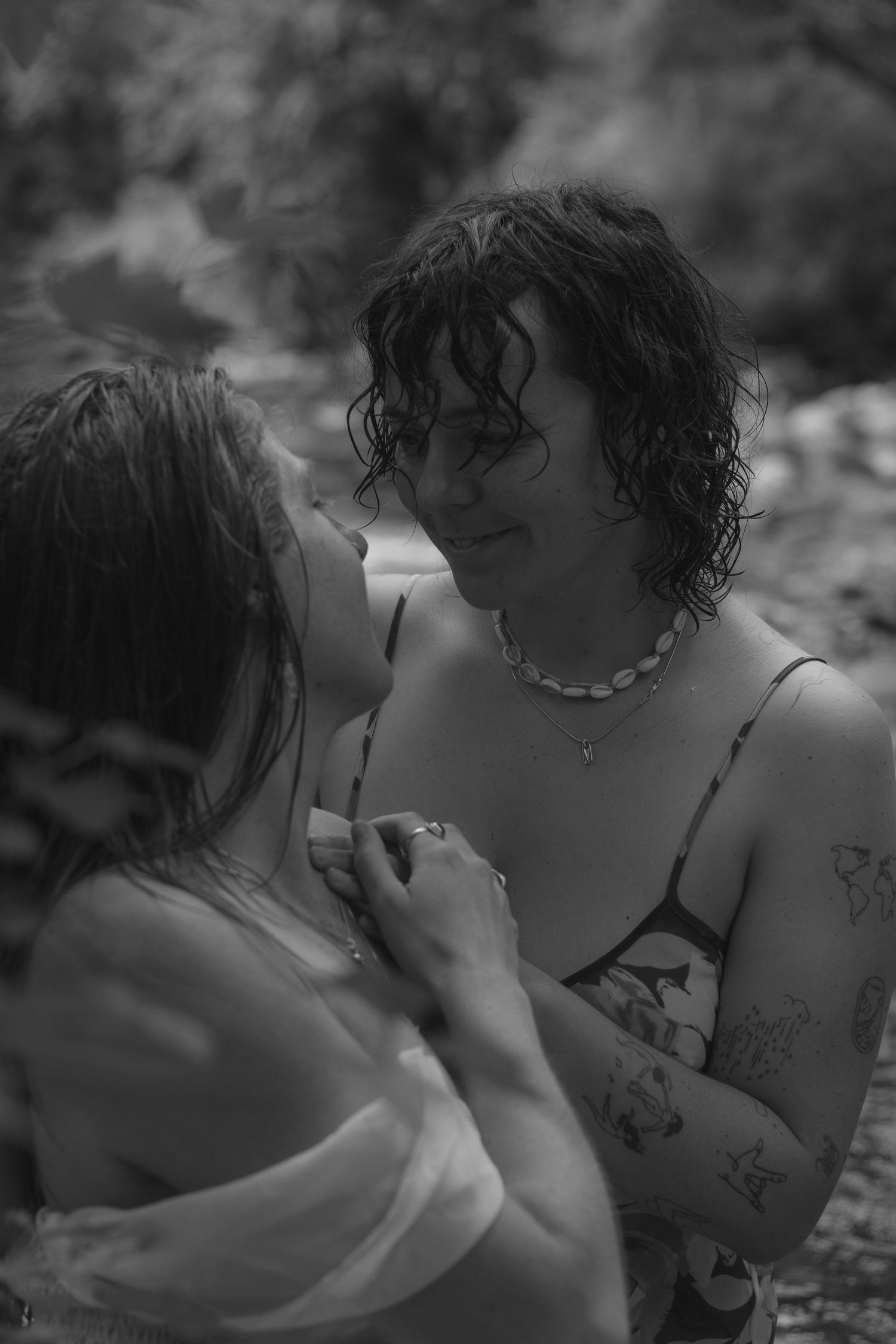 Black and white photo of couple, wet hair, looking at each other. Storytelling photography