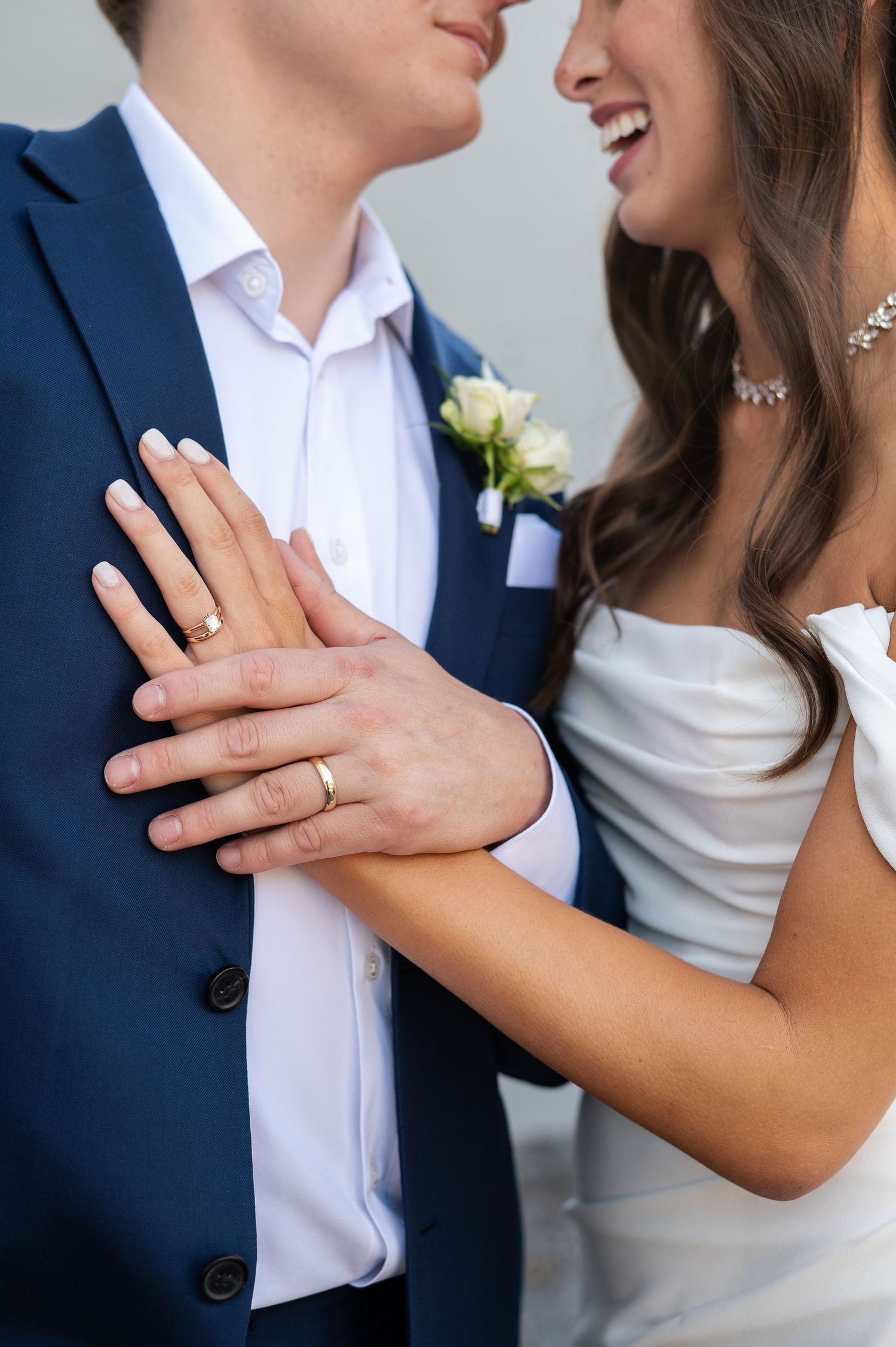 Close-up romantic moments showing wedding rings and embraces.