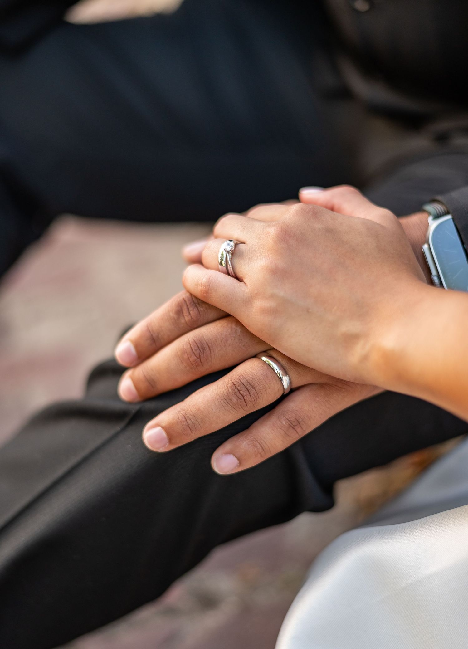 Close-up shots of hands wearing wedding rings during ceremony.