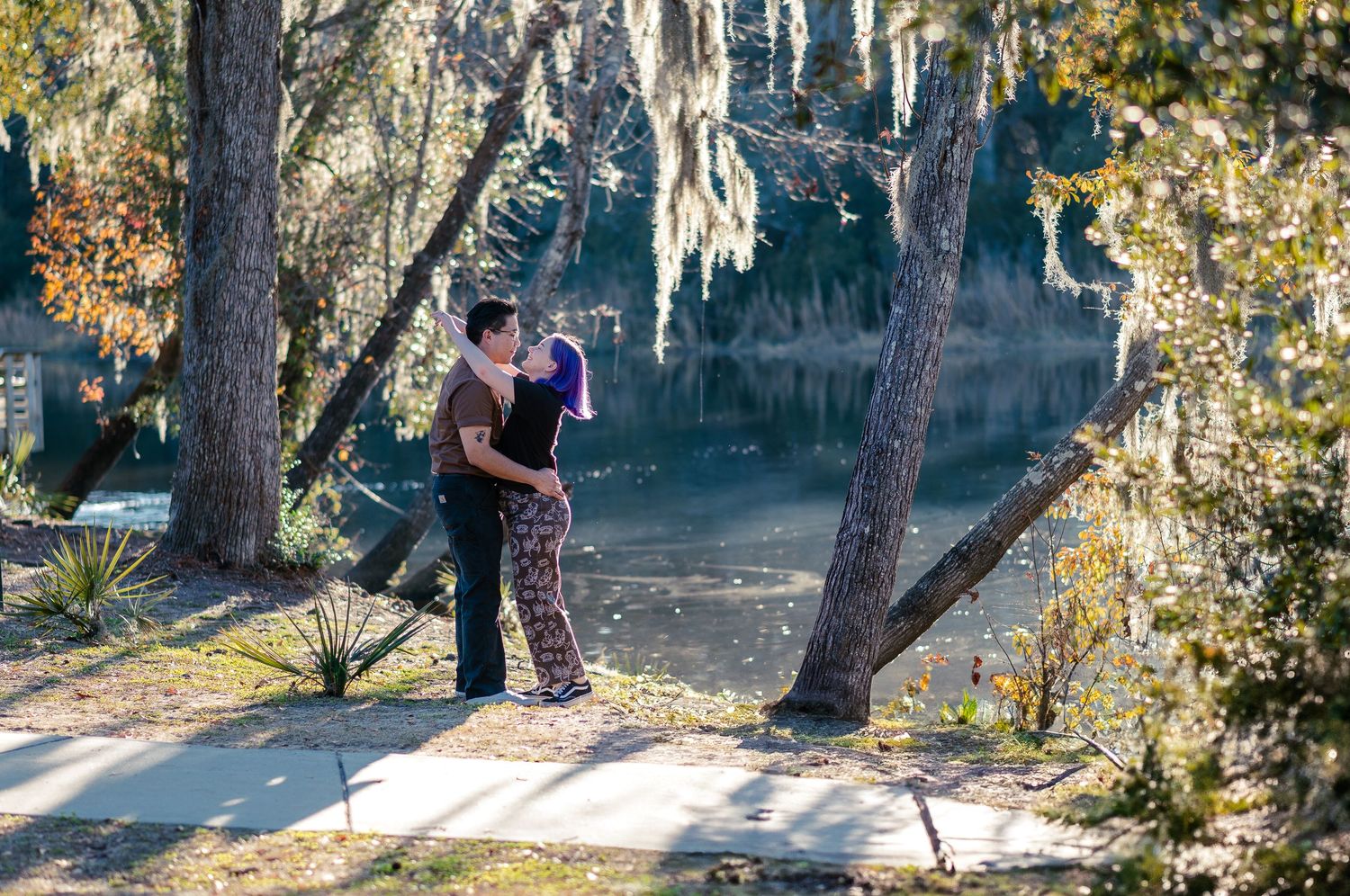 Couples session at Ashley River Blue Trail in Summerville, SC with sun-drenched docks and Spanish moss by Italia Story Co.