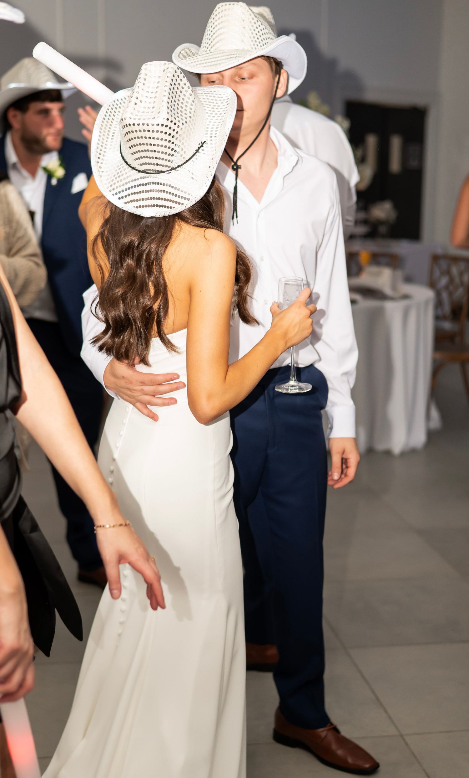 Wedding reception dance sequence with the couple wearing white and navy attire.