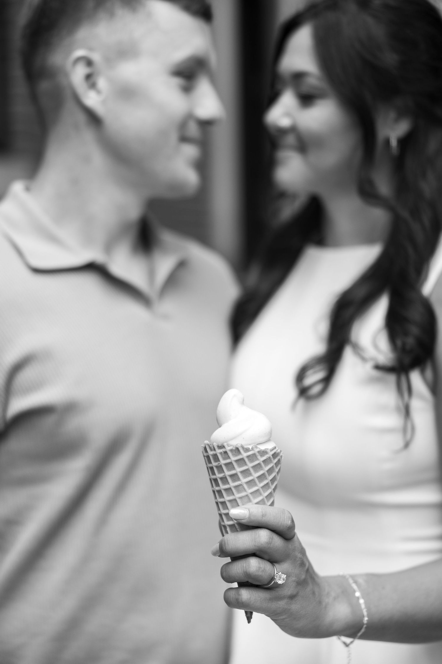 Black and white sequence showing close-ups of hands holding an ice cream cone during an engagement shoot.