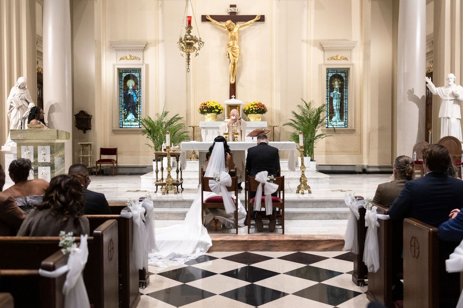 Wide view of a church interior during a wedding ceremony with classic architecture and decor.