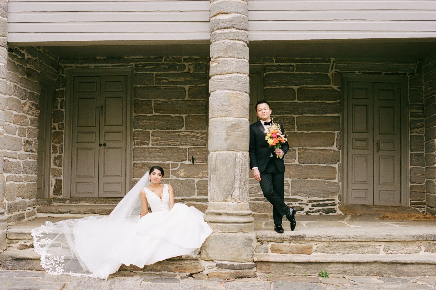 Wedding photo sequence along a historic stone building with columns.