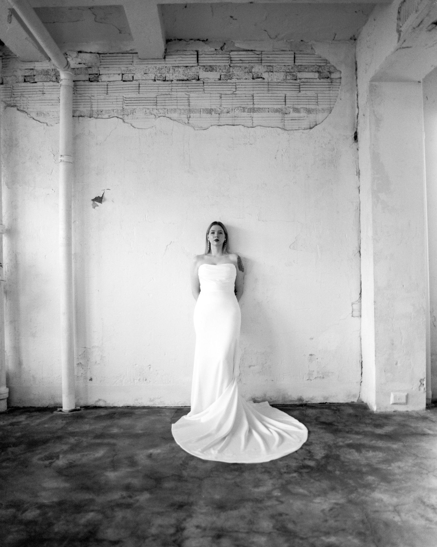 Artistic black and white wedding photography series in minimalist industrial space.
