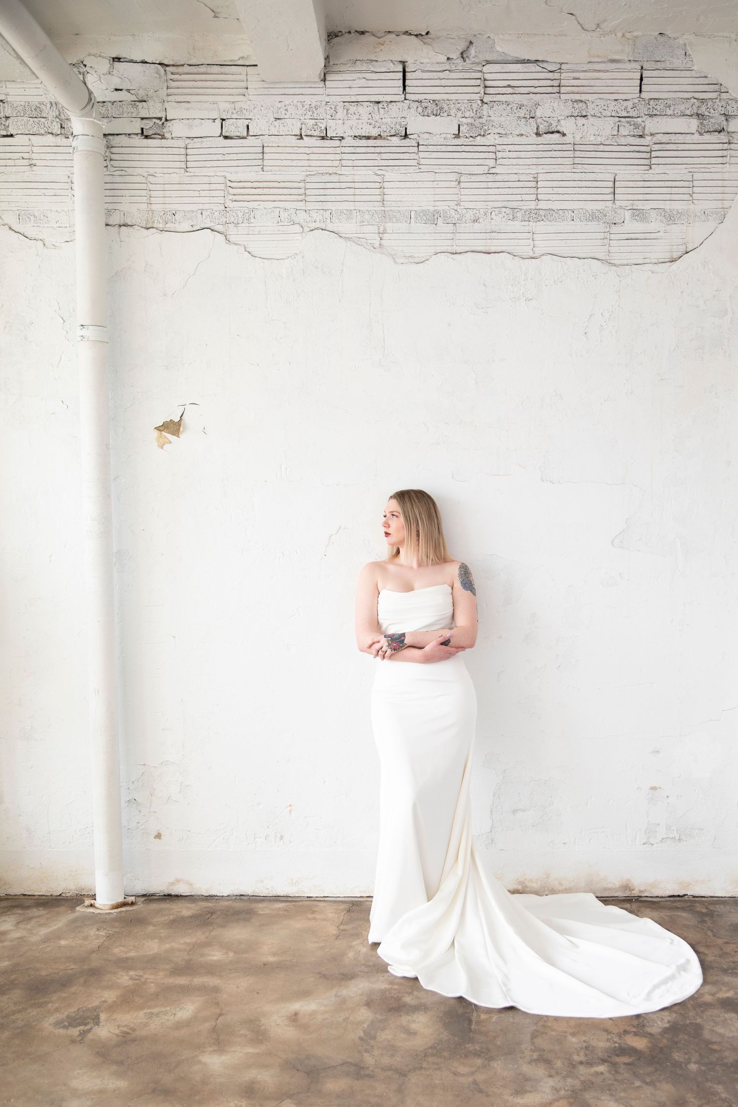 Wedding dress photo series in minimalist industrial space with white walls.