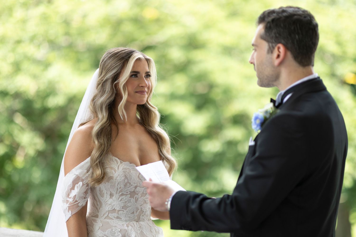 Outdoor wedding portraits with couple sharing emotional first look moment in natural lighting.