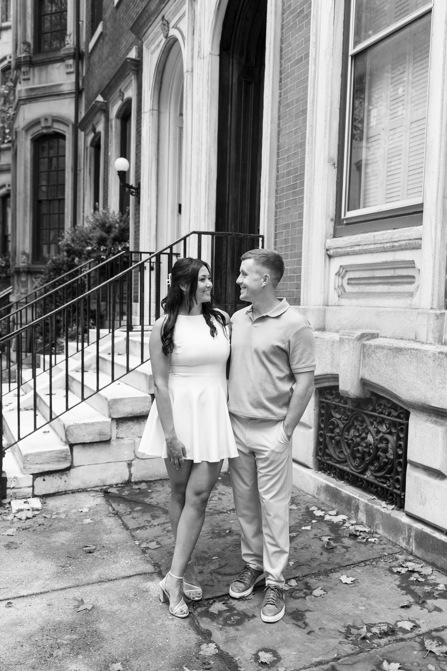 Black and white series of romantic moments captured on urban brownstone steps.