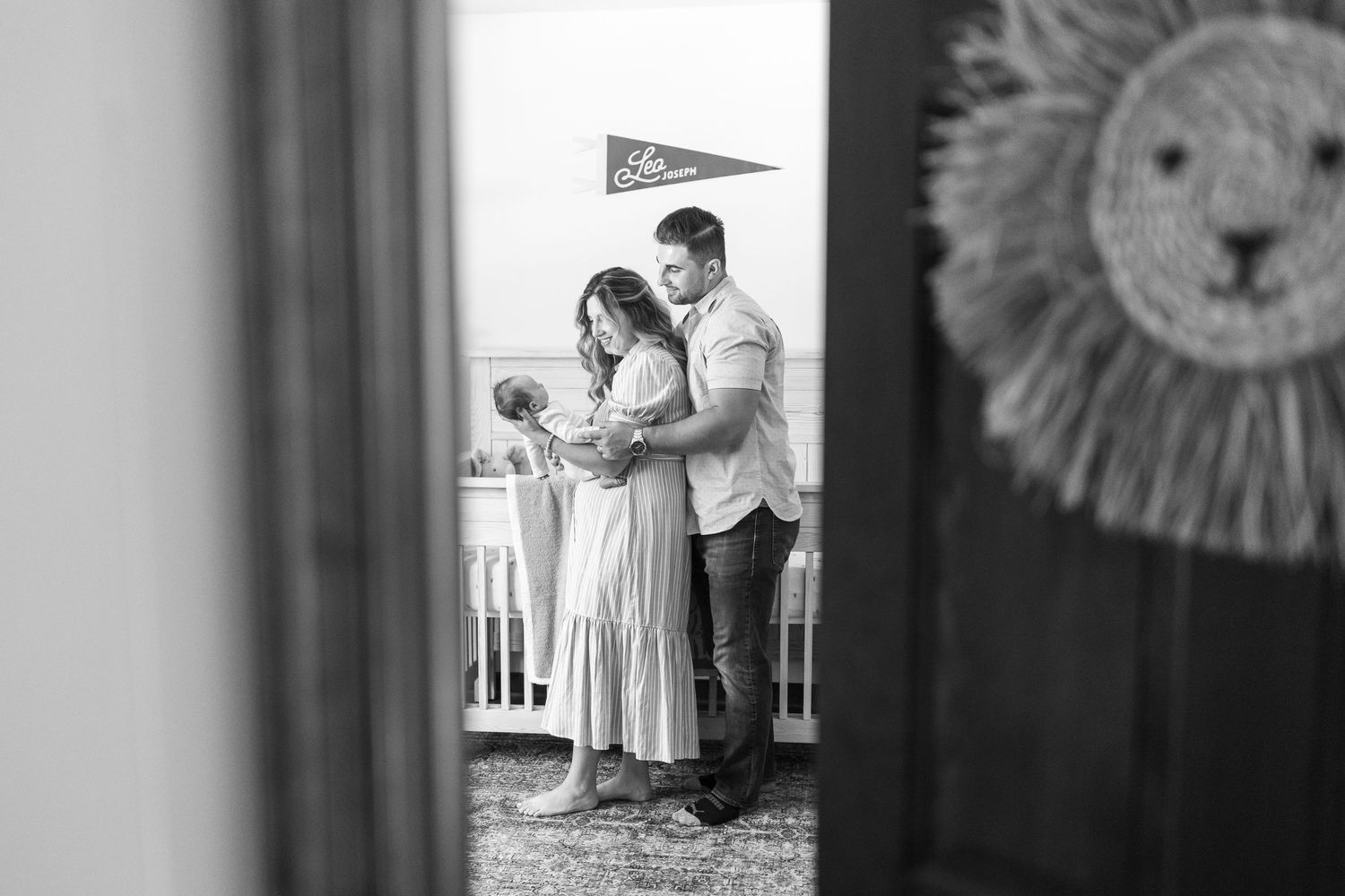 Black and white maternity photos displayed in vintage frames on a wall.
