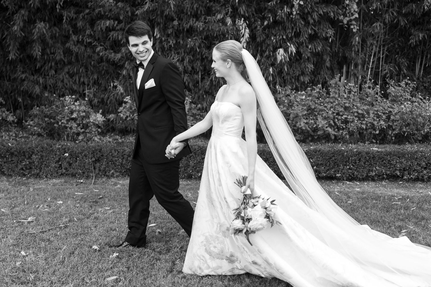 A black and white wedding photo sequence showing movement and elegance in an outdoor setting.