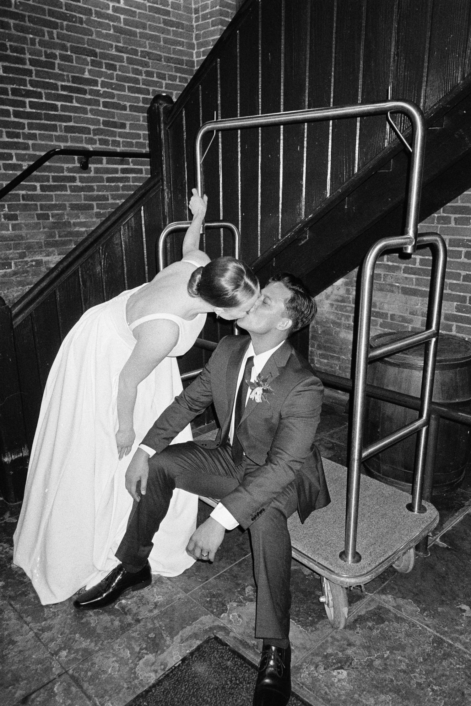 Black and white sequence of playful moments on brick staircase.