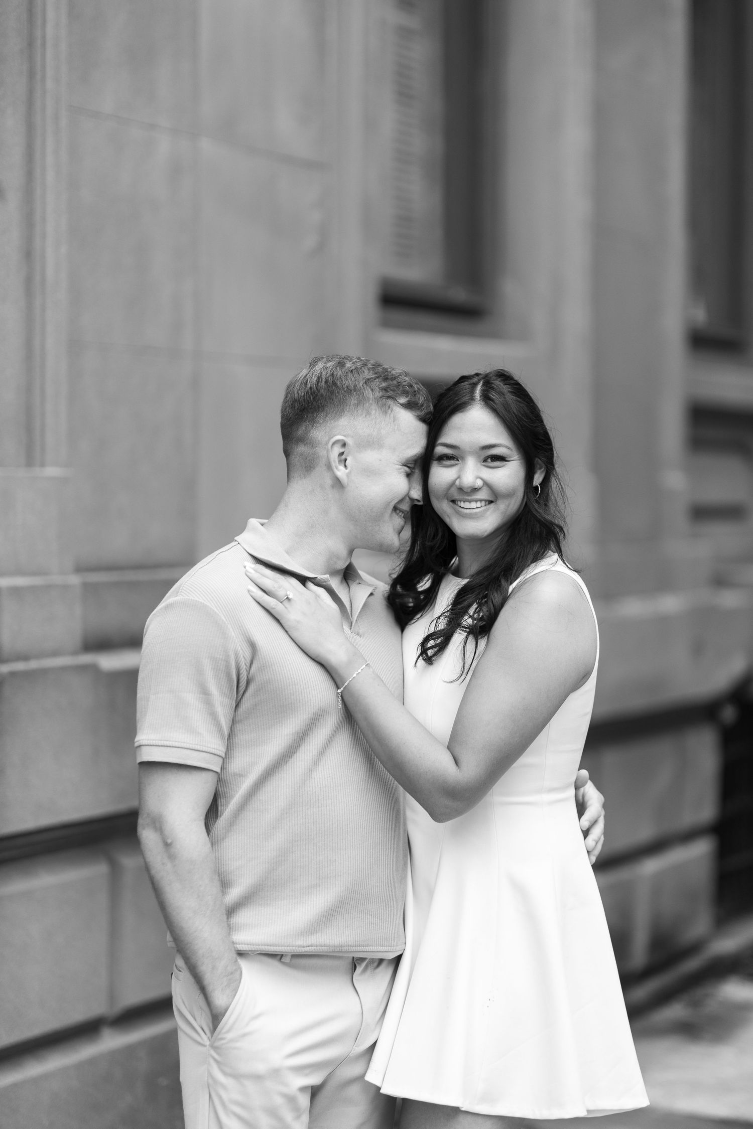 Black and white engagement portraits showing joyful laughter and natural connection.