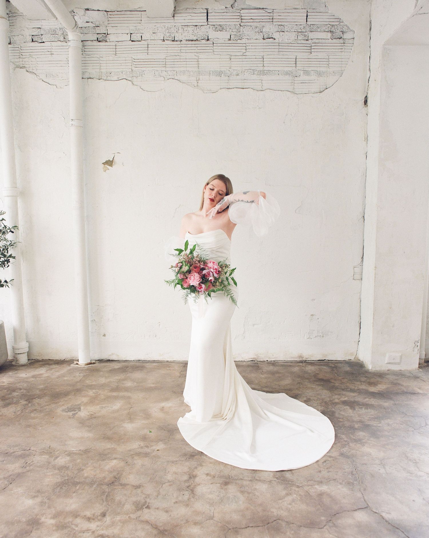 Dynamic bridal portrait with spinning movement captured in bright industrial space.