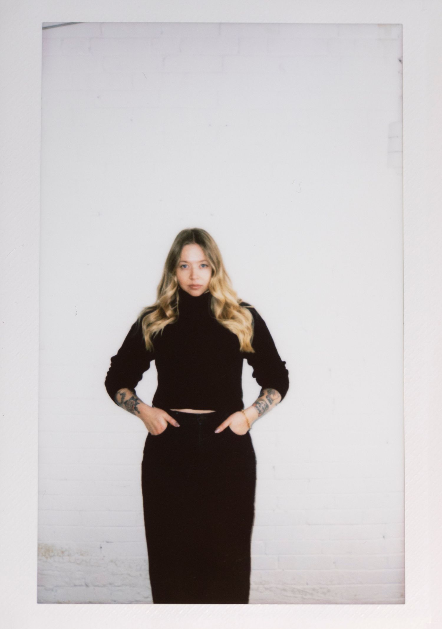 A series of three minimalist fashion photos featuring a black turtleneck dress against a white background.