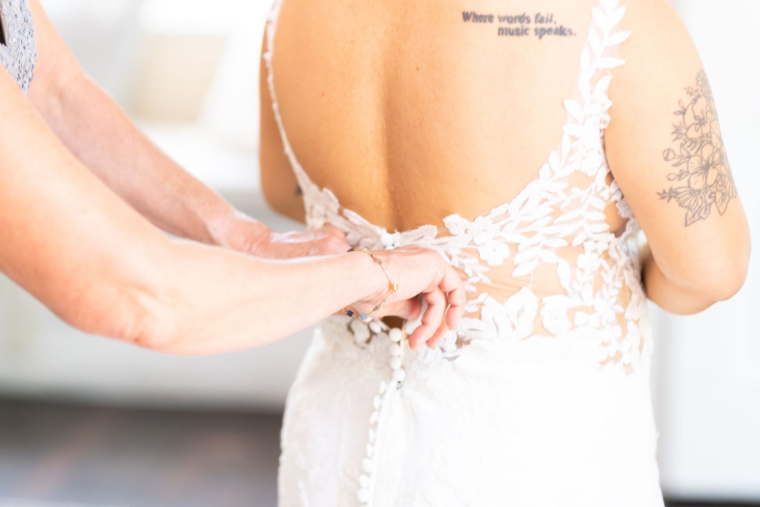 Close-up details of delicate lace trim on a white wedding dress.
