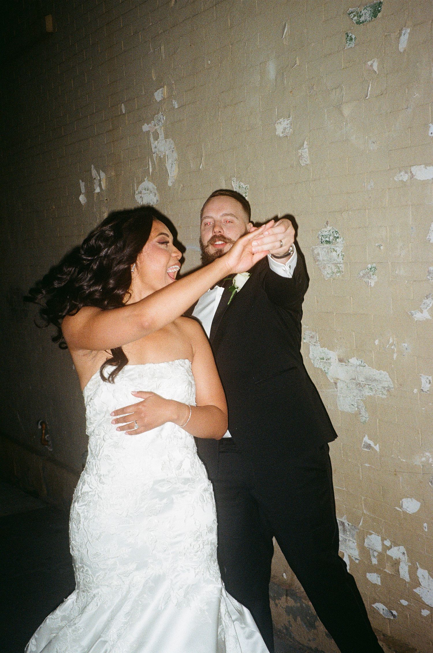 A couple dances and twirls in formal wedding attire.