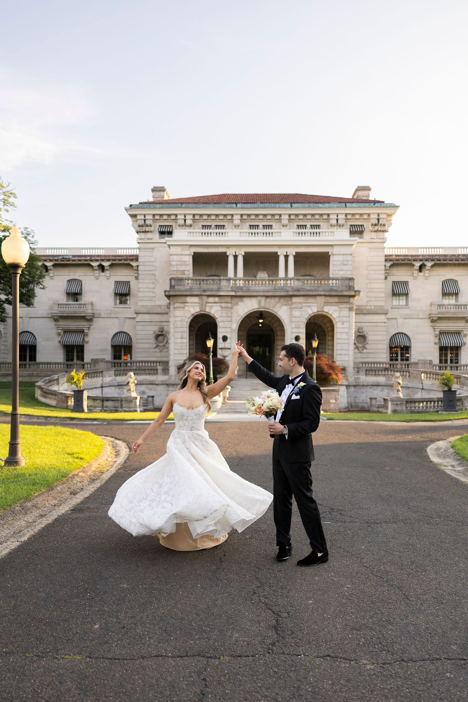 Wedding photography sequence showing movement and dance outside a historic stone building.