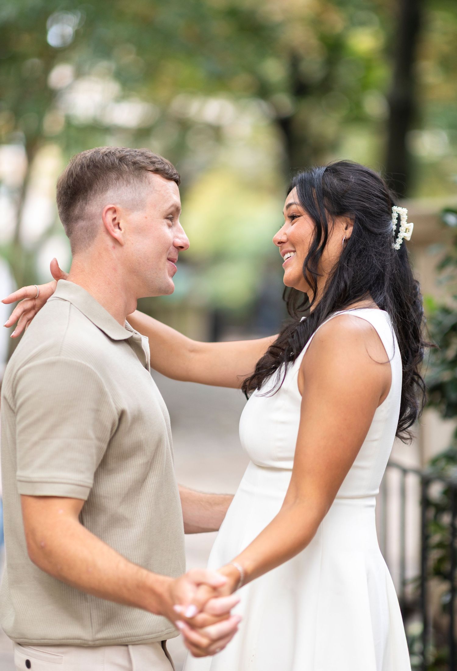 A couple shares a joyful dance moment during their engagement photoshoot.