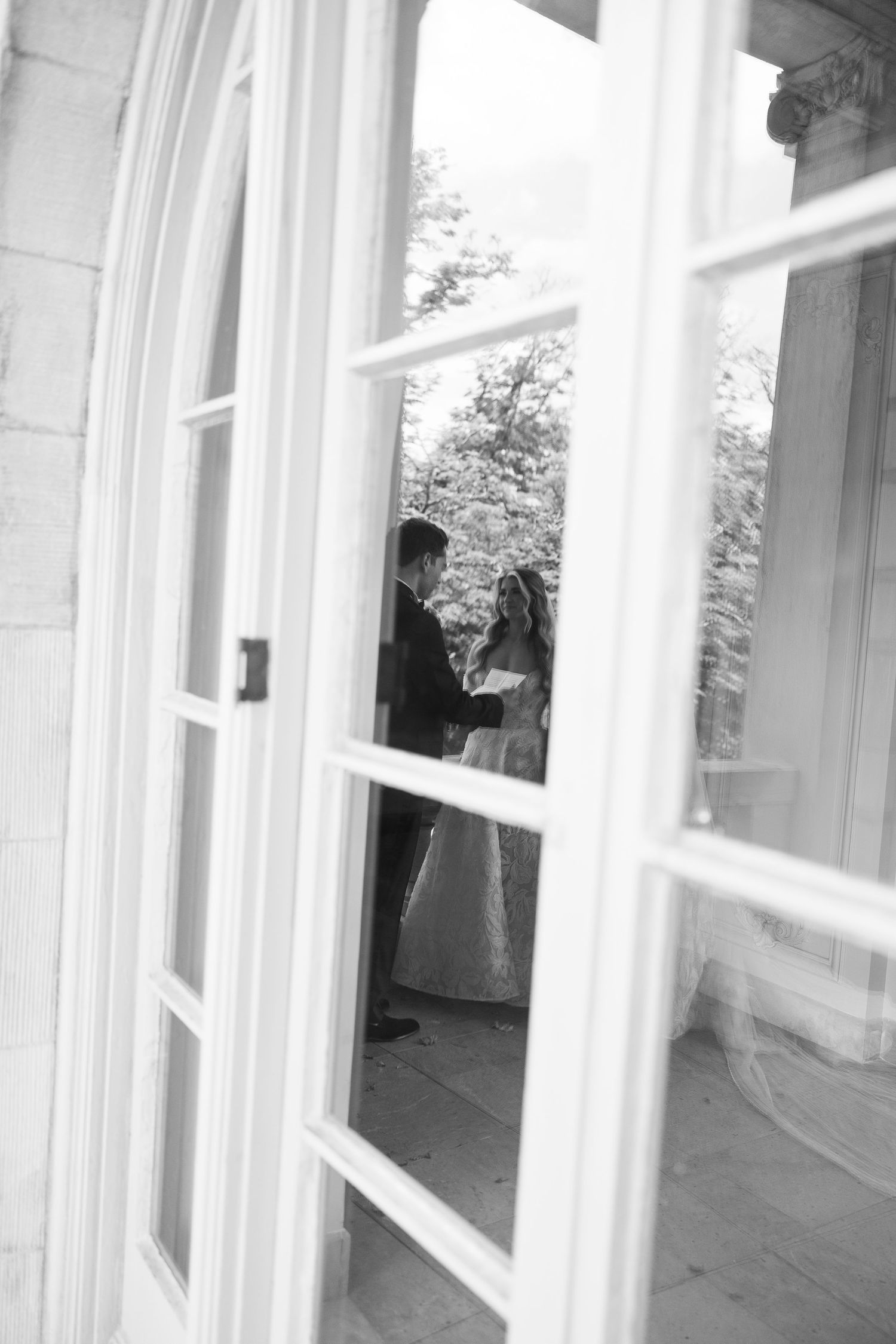 Elegant wedding venue interior featuring white trim windows and stone architectural details.