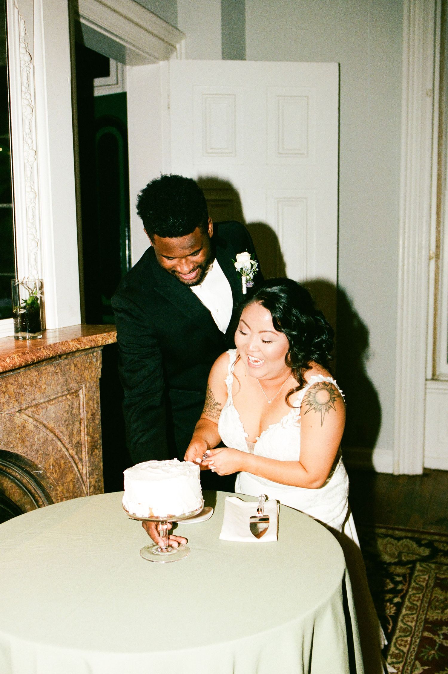 Intimate reception moments captured between couple at white-clothed table.