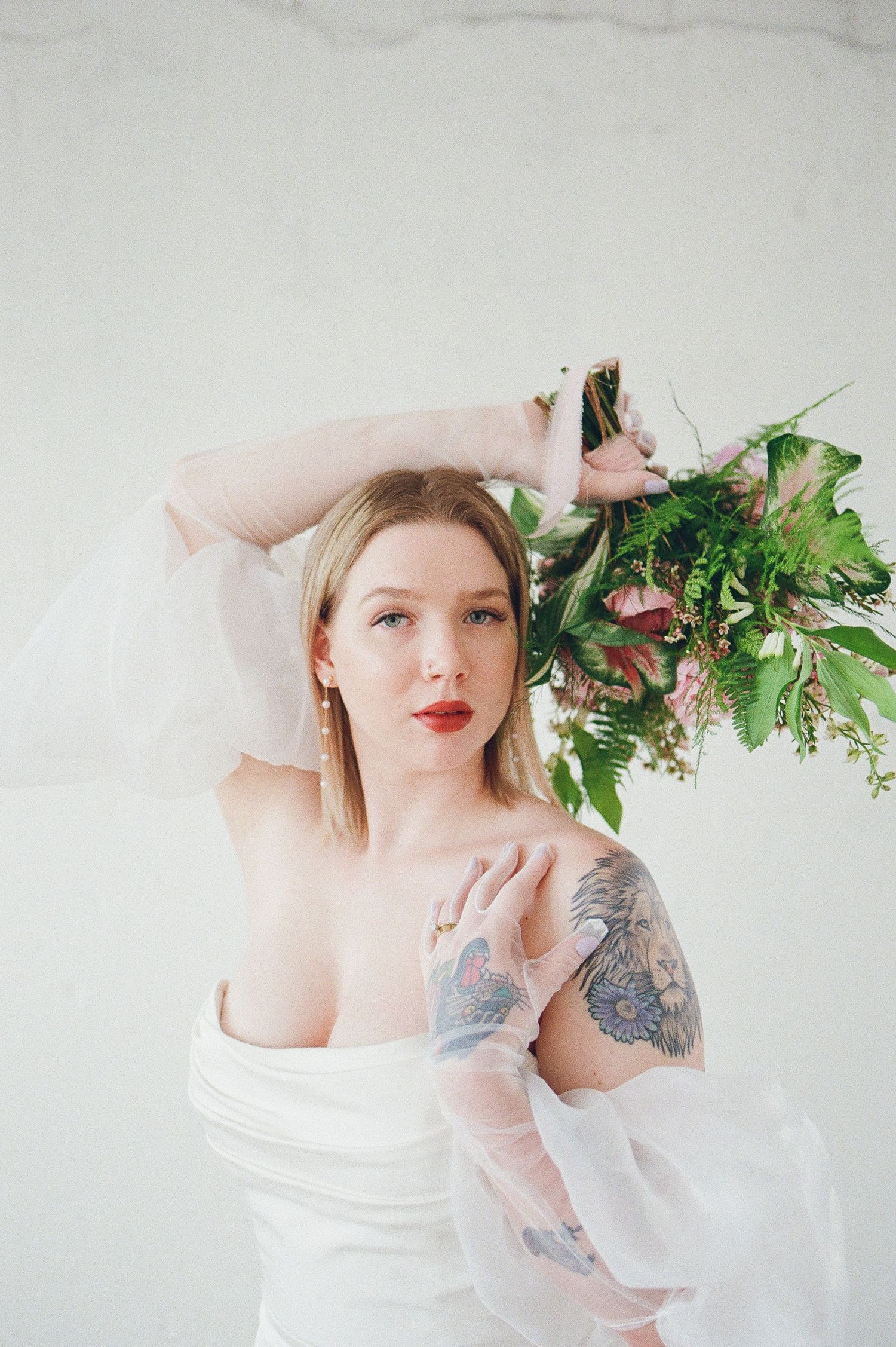 Ethereal bridal portraits incorporating natural greenery and delicate styling elements.