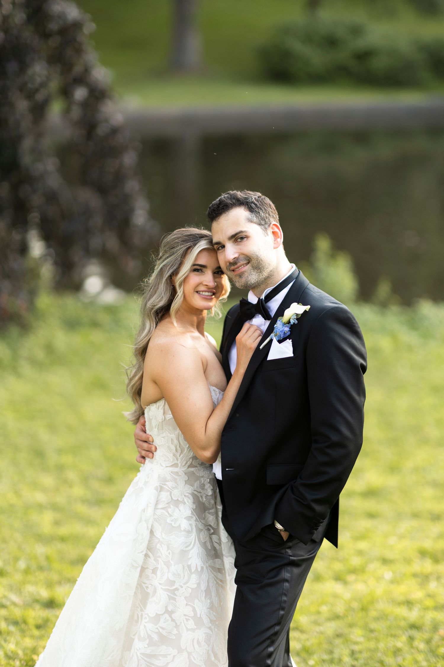 Romantic wedding portraits captured in a lush green garden setting.
