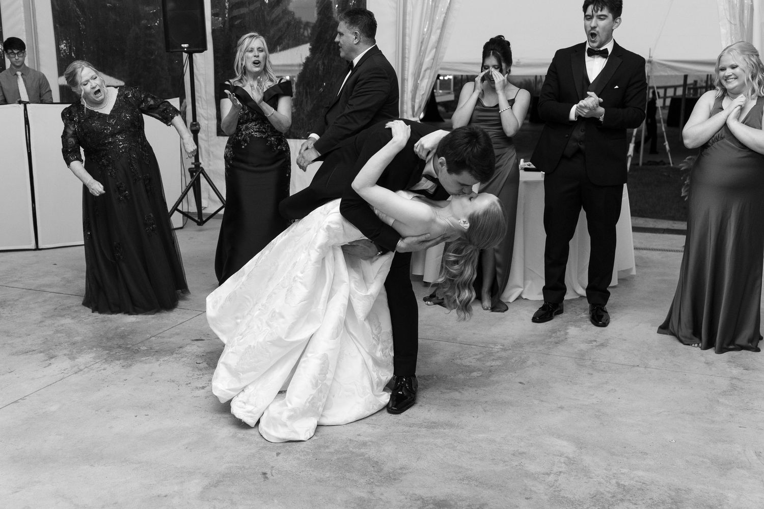 Wedding couple dancing together in formal attire during their first dance at an elegant reception.
