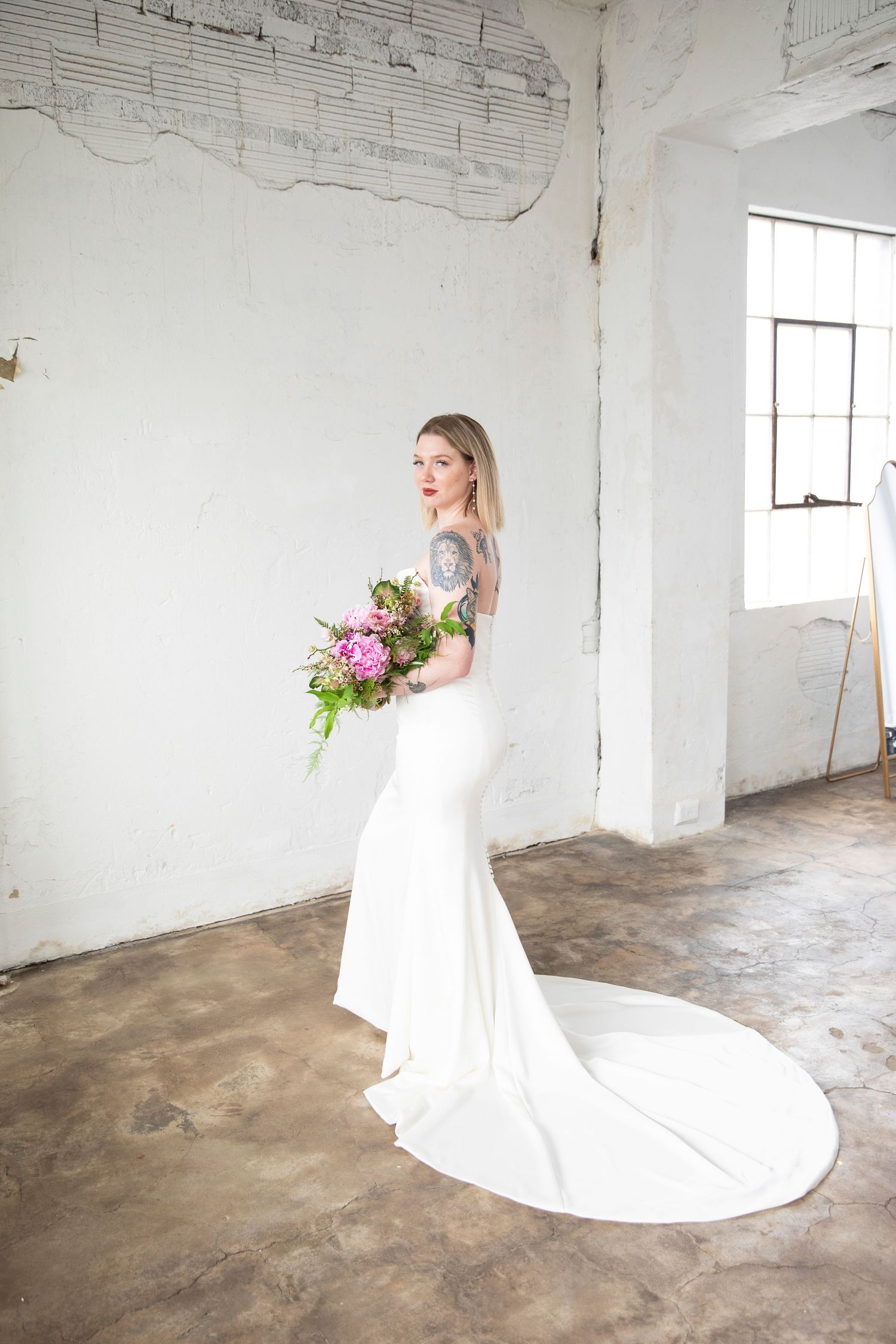 Wedding photography in minimalist white industrial space.
