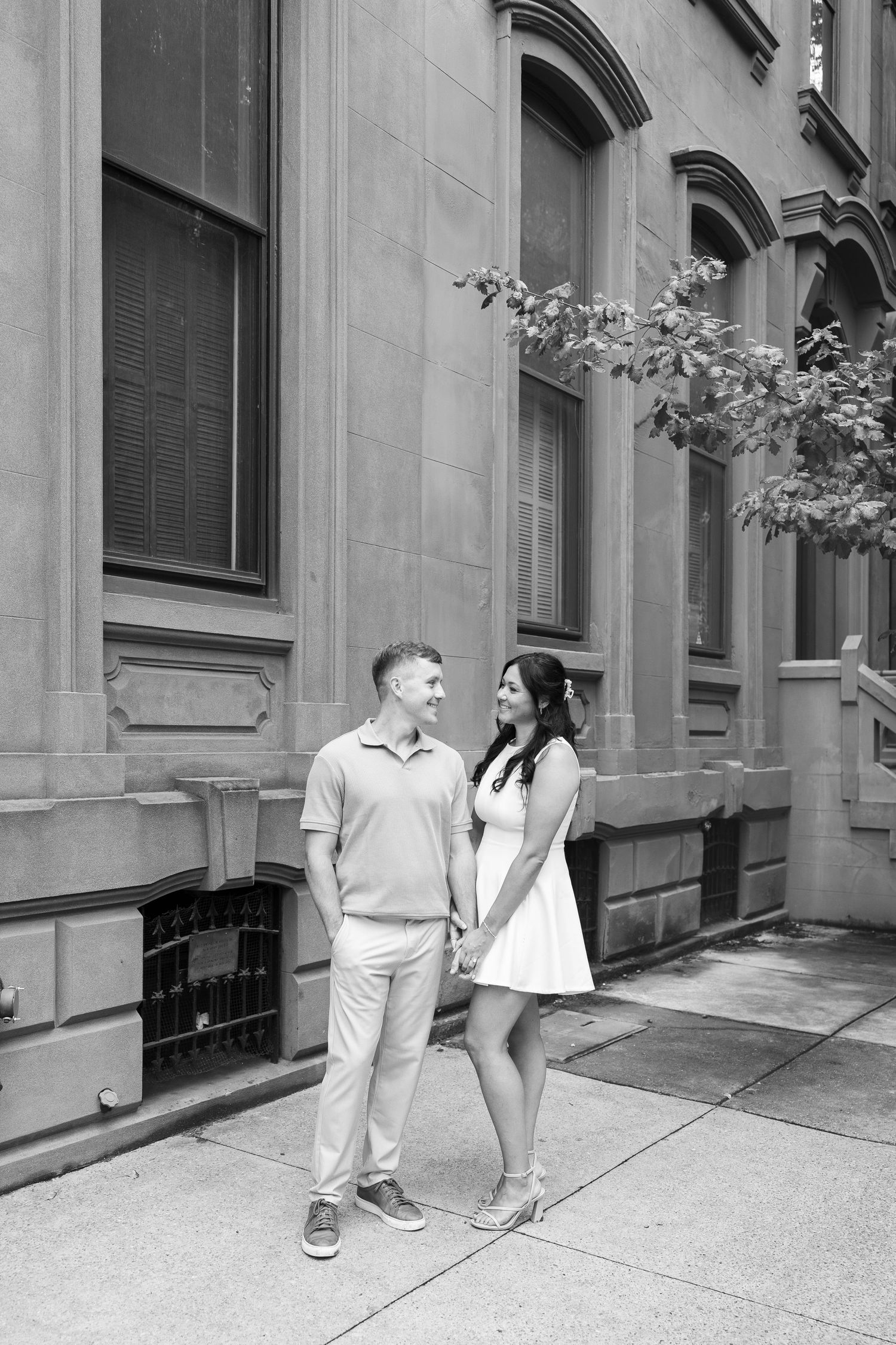 Classic black and white engagement photos against architectural backdrop.