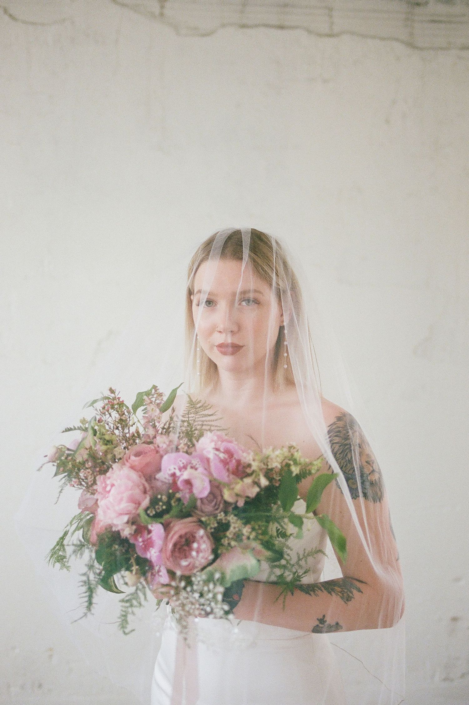 Romantic bridal portraits with soft pink florals and delicate veil details.