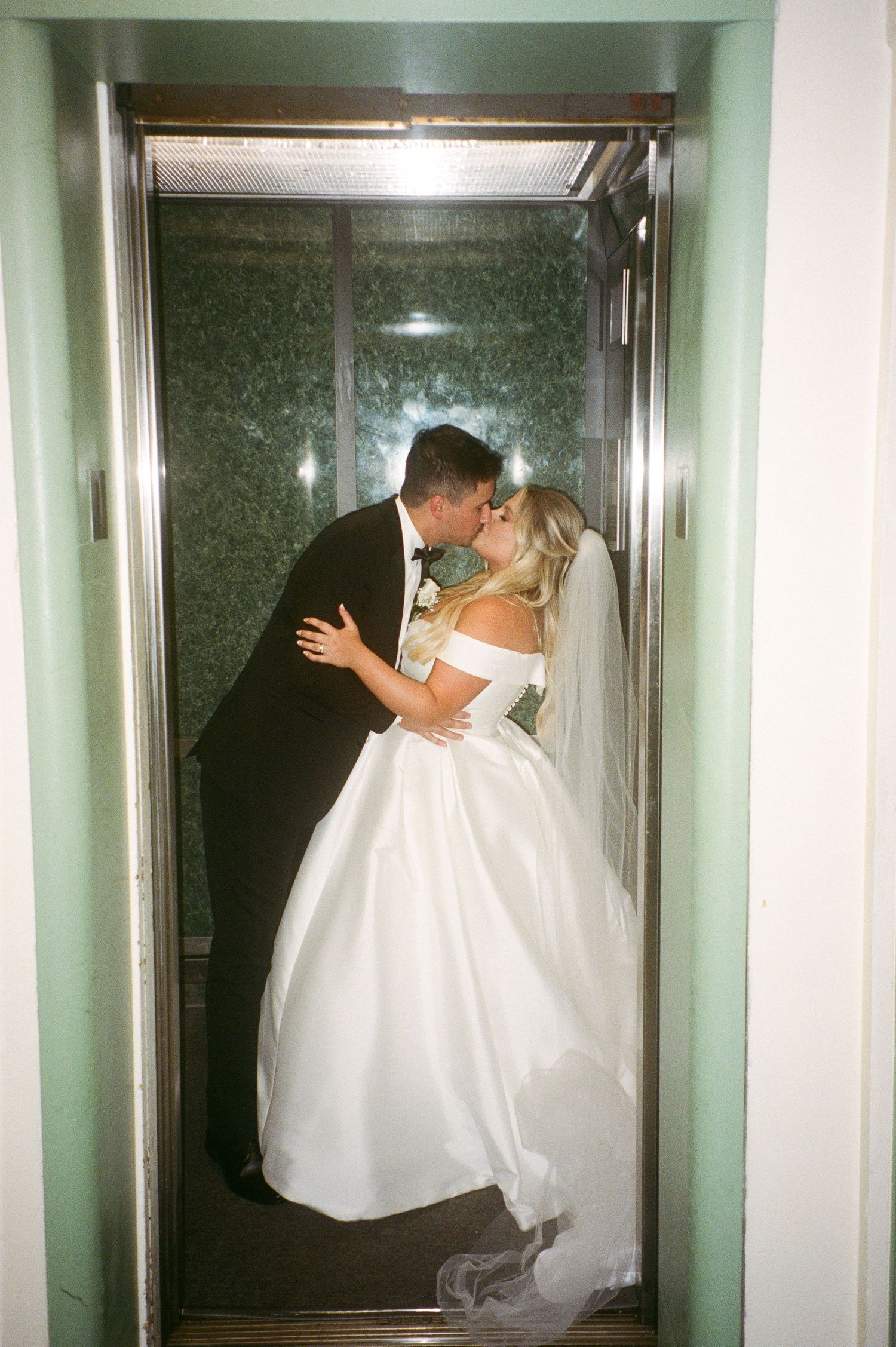A romantic series of elevator photos showing a couple in wedding attire sharing intimate moments.